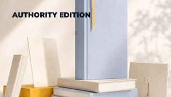 Authority Edition — a tall hardback on a plinth of stacked books with a folder and loose covers around it