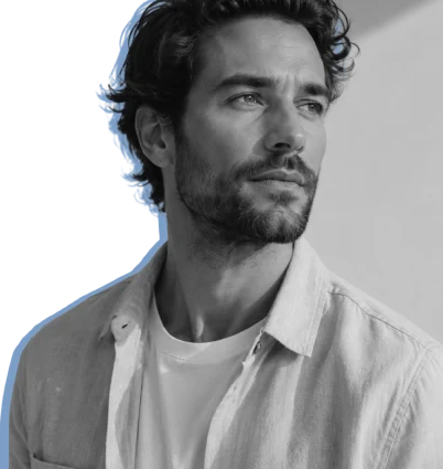 A practitioner in a linen shirt sitting for a portrait, traced by a hand-drawn blue outline